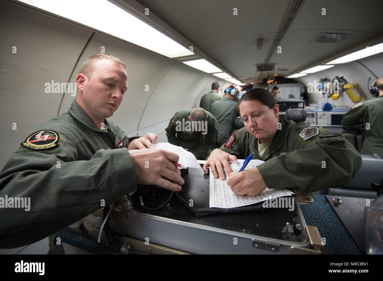 Senior Airman Dustin Tompkins, assigned to the 970th Airborne Air Control Squadron, and Maj. Anne Ridlon, from the 513th Operations Support Squadron, make notes during pre-flight preparations on board an E-3 Sentry Airborne Warning and Control System aircraft June 6, 2017, at NATO Air Base Geilenkirchen, Germany. Both Airmen are a part of the nearly 100 reservists supporting the BALTOPS 2017 exercise, which involves 50 ships and submarines and 40 aircraft from 14 member nations. (U.S. Air Force photo/2nd Lt. Caleb Wanzer) Stock Photo