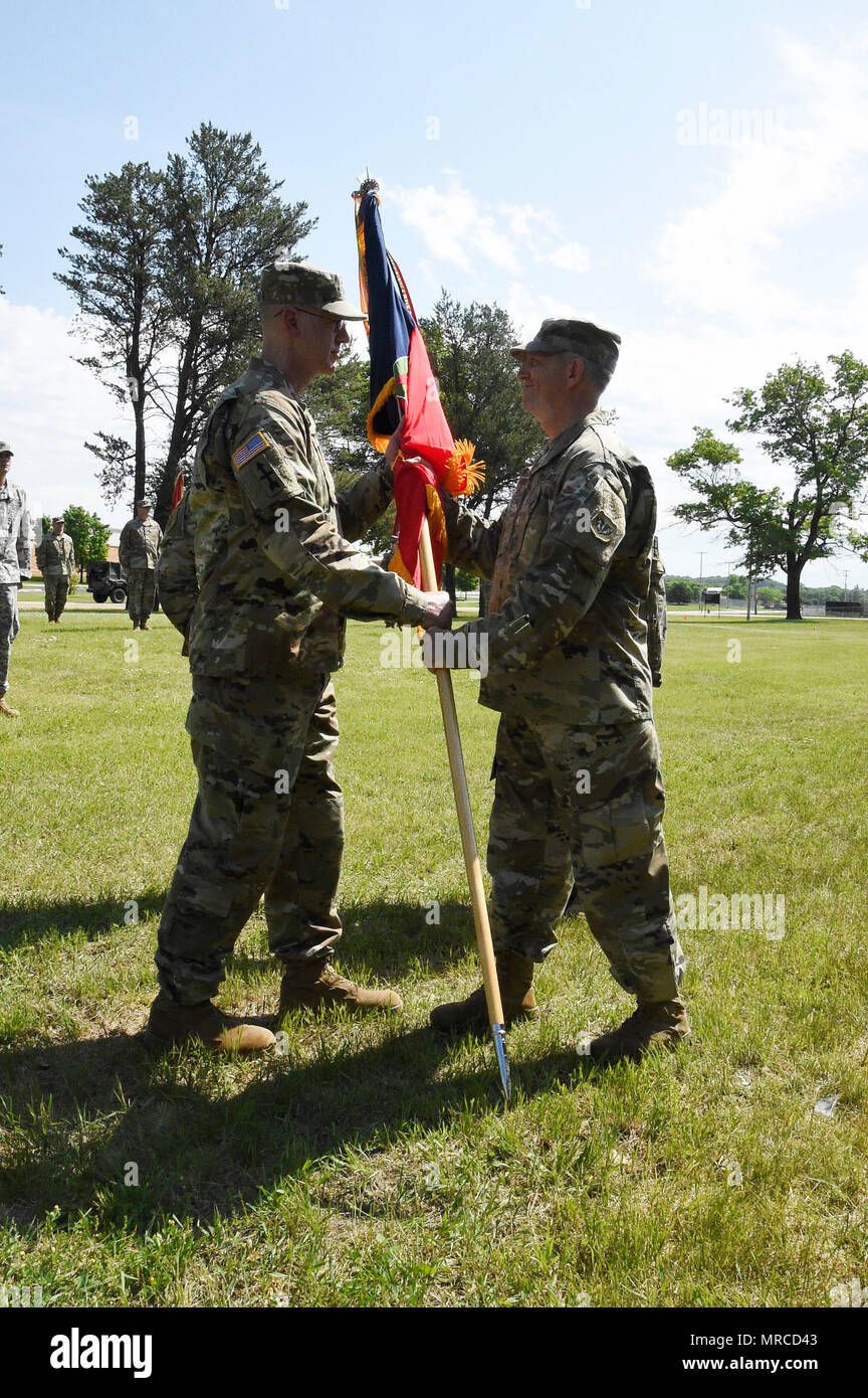 Brig. Gen. Mark Anderson, Wisconsin’s deputy adjutant general for Army, presents the brigade colors to incoming 32nd Infantry Brigade Combat Team commander Col. John Oakley during a formal change of command ceremony June 3 at Fort McCoy, Wis.  Oakley follows Col. Michael George as commander of the Red Arrow Brigade. The 32nd IBCT is the Wisconsin Army National Guard’s largest brigade, and descends from the historic 32nd Division which formed 100 years ago as the United States prepared to enter World War I. Wisconsin Department of Military Affairs photo by Vaughn R. Larson Stock Photo