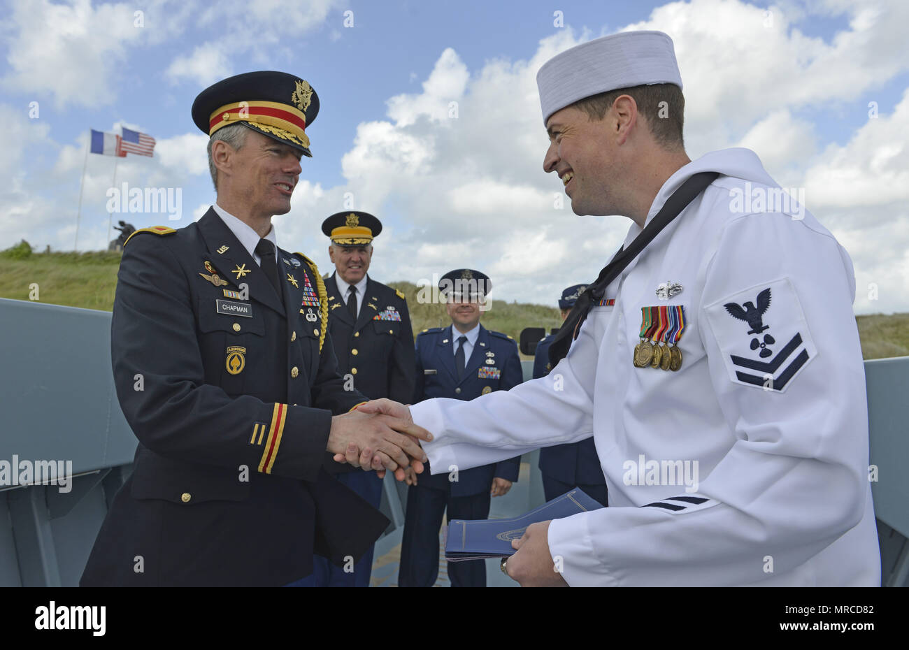 Colonel David K. Chapman, defense attaché to France, congratulates