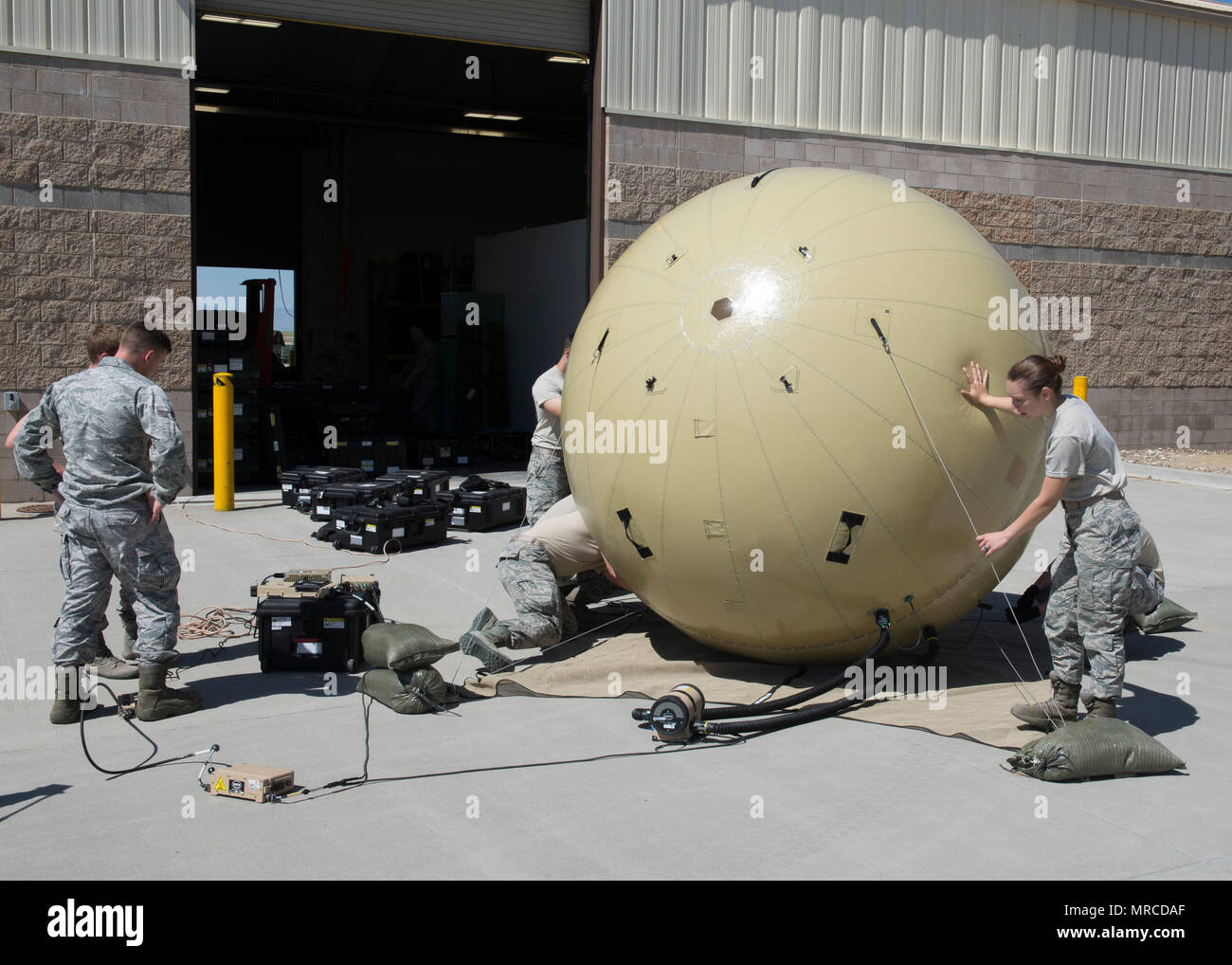Members of the 726th Air Control Squadron assemble a Small Communications Package May 30, 2017, at Mountain Home Air Force Base, Idaho.  The inflatable system allows smaller teams to transport and employ it without relying on outside agencies. (U.S. Air Force photo by Airman 1st Class Jeremy D. Wolff/Released) Stock Photo