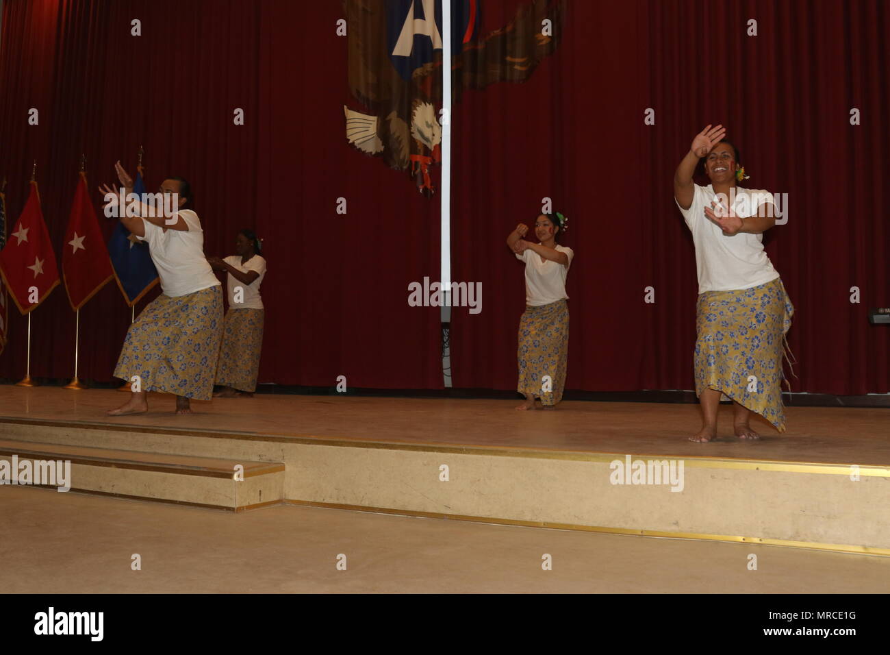 Servicemembers perform the Siva Samoa dance celebrating Samoan culture, May 31, Camp Arifjan, Kuwait. The Samoan dance involves both traditional and modern forms of choreography that celebrates its culture. This dance requires the person to retain grace; because the movement of the arms and hands are done so in a subtle but delicate manner. Asian American and Pacific Islanders concluded the month of May with a heritage dance and celebratory food sampling. Stock Photo