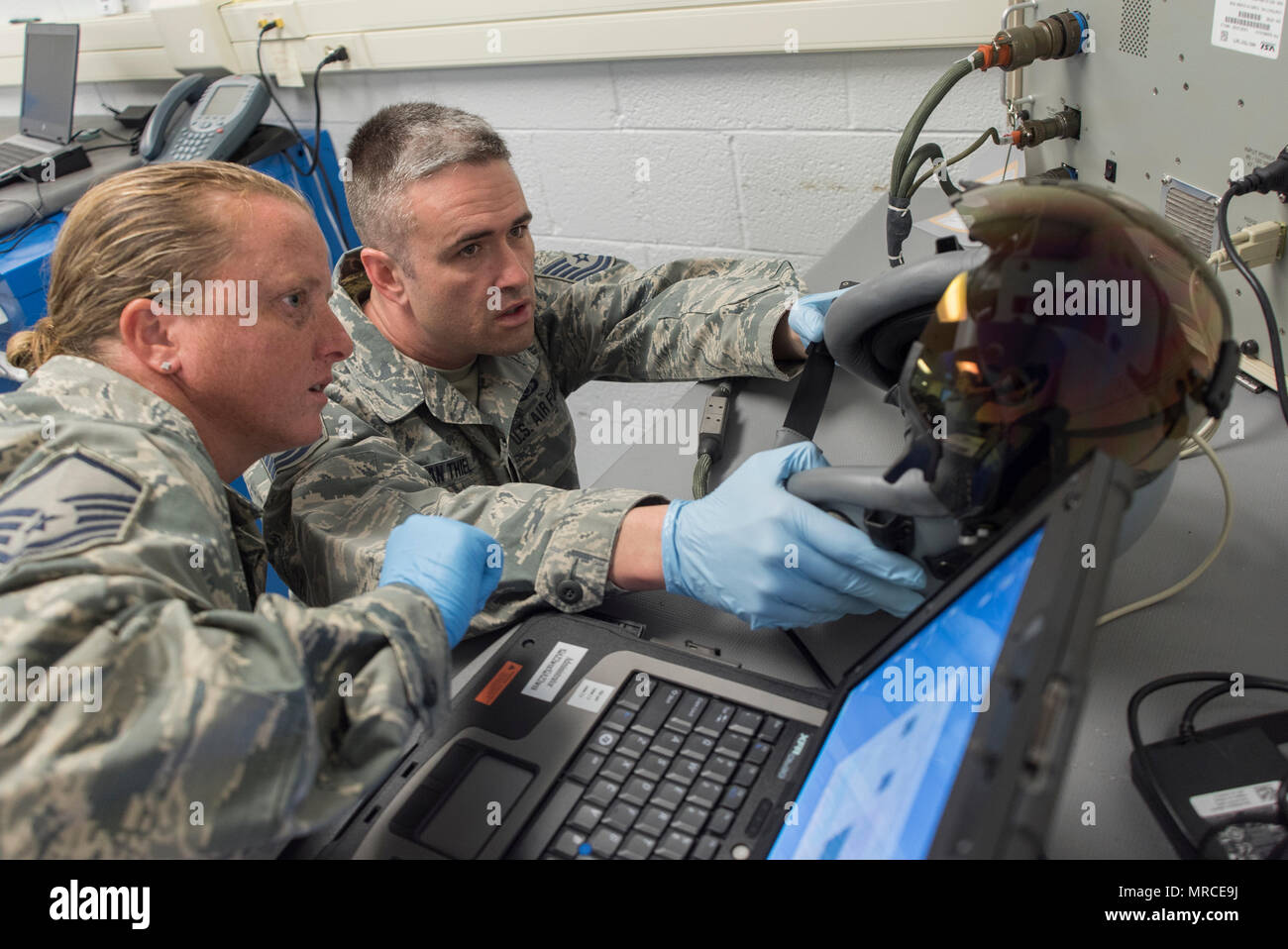 Air Force Reserve Master Sgt. Brandi Bray and Tech. Sgt. Eduard Van Thiel, 339th Flight Test Squadron aircrew flight equipment, operate a head-mounted display test system April 26, 2017, at Robins Air Force Base, Georgia. Aircrew flight equipment Airmen with the 339th FLTS are responsible for performing inspections, maintenance and adjustments to F-15 and C-5 flight and safety equipment. (U.S. Air Force photo by Jamal D. Sutter) Stock Photo
