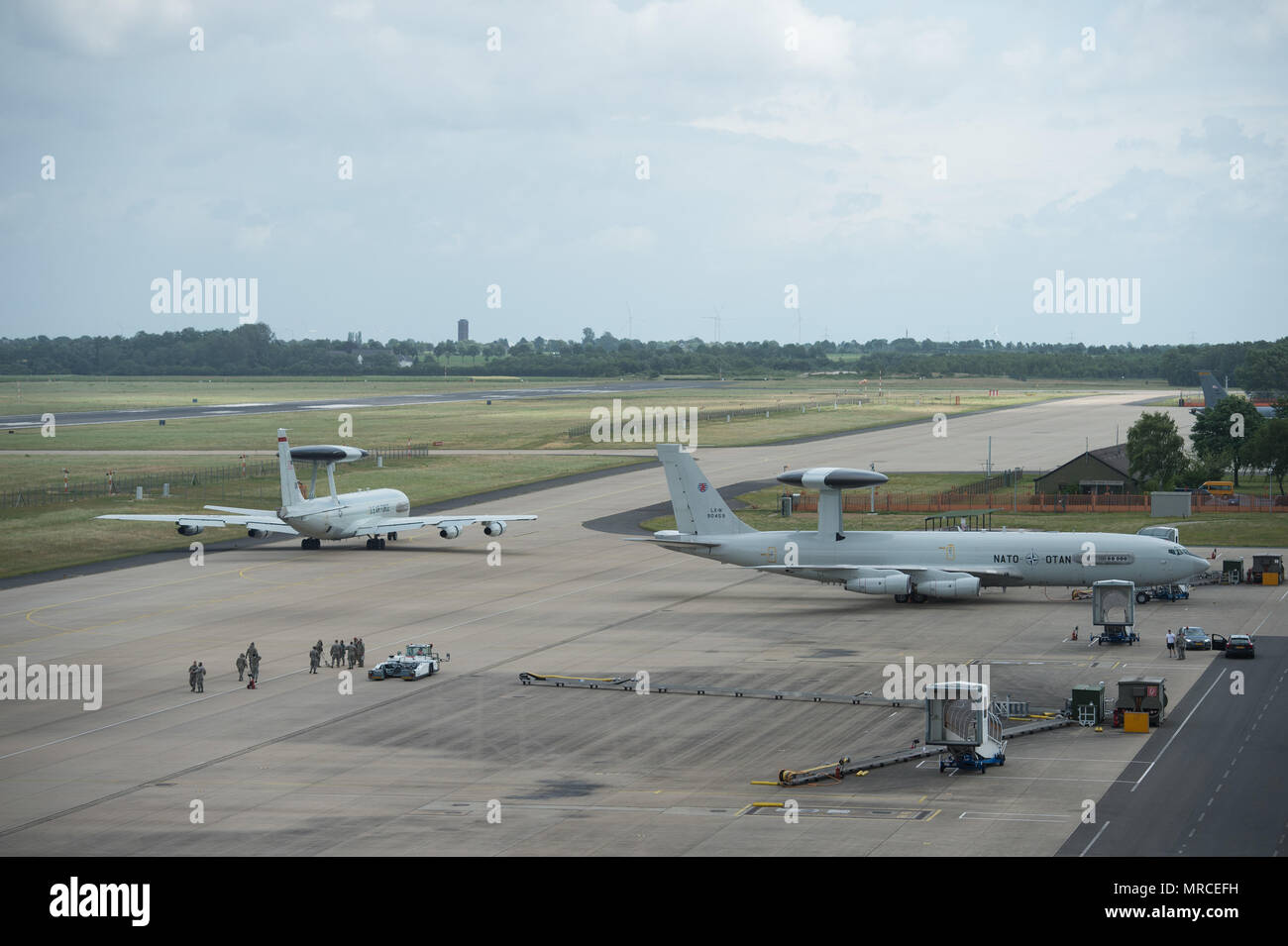 A U.S Air Force E-3 Sentry taxis past a NATO E-3A Airborne Warning and Control System aircraft on June 7, 2017, at NATO Air Base Geilenkirchen, Germany. The aircraft and nearly 100 reservists from the 513th Air Control Group are deployed in support of BALTOPS 2017, which is the first time a U.S. E-3 Sentry has supported a NATO exercise in 20 years. (U.S. Air Force photo/2nd Lt. Caleb Wanzer) Stock Photo
