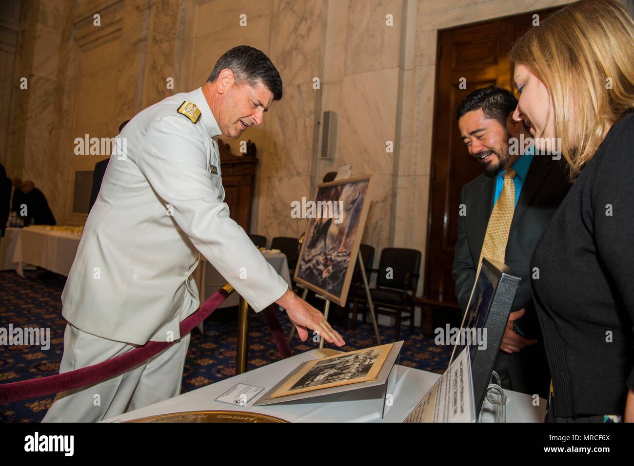 170606-N-XP477-0110   WASHINGTON (Jun. 06, 2017) Vice Chief of Naval Operations, Adm. Bill Moran examines World War II memorabilia on display by the Naval History and Heritage Command at the 2017 Navy Legislative Affairs' Battle of Midway Ceremony. The ceremony was held to commemorate the 75th anniversary of the Battle of Midway which was the turning point of the United States' victory over Japan in the Pacific theater, and allowed the U.S. and the Allied Forces to concentrate their efforts to defeat Germany in Europe and end WWII. (U.S. Navy photo by Mass Communication Specialist 2nd Class Da Stock Photo