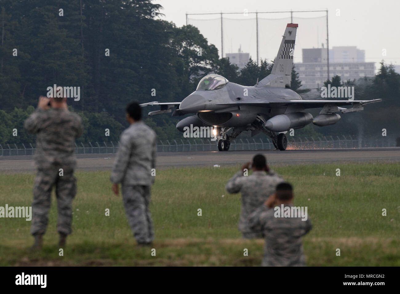 Airmen with the 374th Civil Engineer Squadron observe an F-16 Fighting Falcon test an Aircraft Arresting System, June 1, 2017, Yokota Air Base, Japan. The AAS is required to be tested annually. Airmen from the 374 CES and 374th Operations Support Squadron are responsible for setting up the system and logging any deficiencies during the test. (U.S. Air Force photo by Yasuo Osakabe) Stock Photo