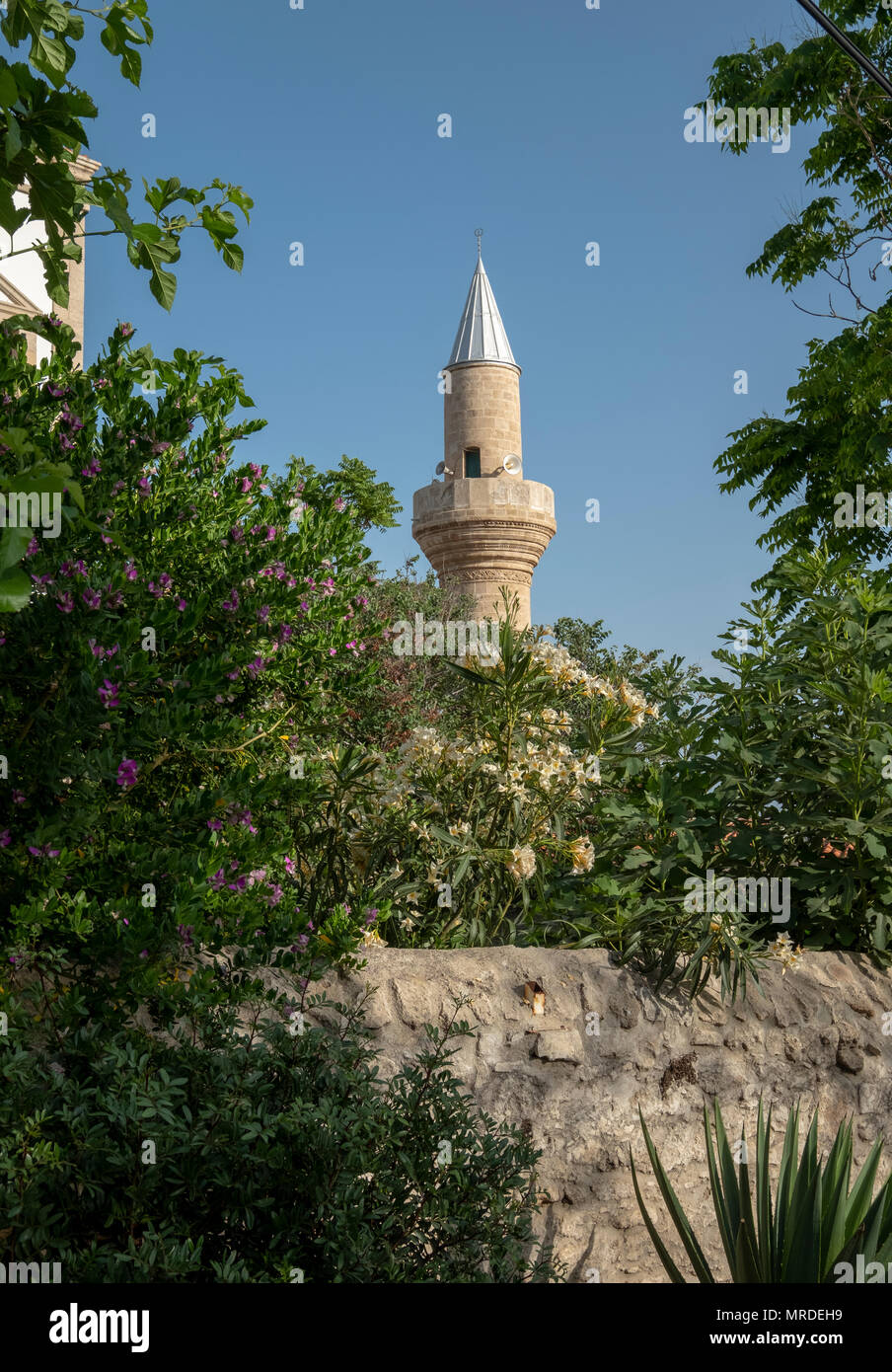 The minaret of Ağa Cafer Pasha Mosque in Kyrenia harbour, Northern Cyprus Stock Photo