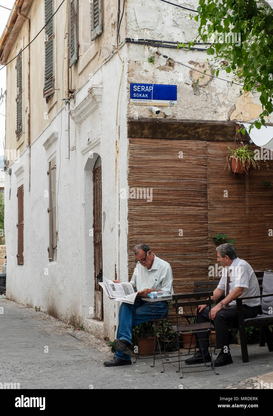 two men sitting in Serap Sokak, Kyrenia (Turkish:Girne) in Northern Cyprus. Stock Photo