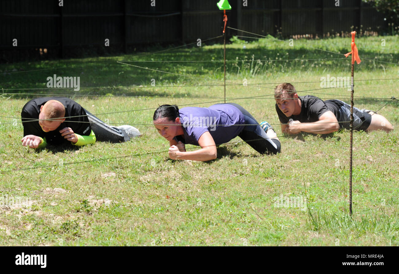 81st Medical Operations Squadron Team 2 members participate in the low crawl portion during the 81st Security Forces Squadron obstacle course competition May 16, 2017, on Keesler Air Force Base, Miss. The competition was held during National Police Week, which recognizes the service of law enforcement men and women. (U.S. Air Force photo by Kemberly Groue) Stock Photo