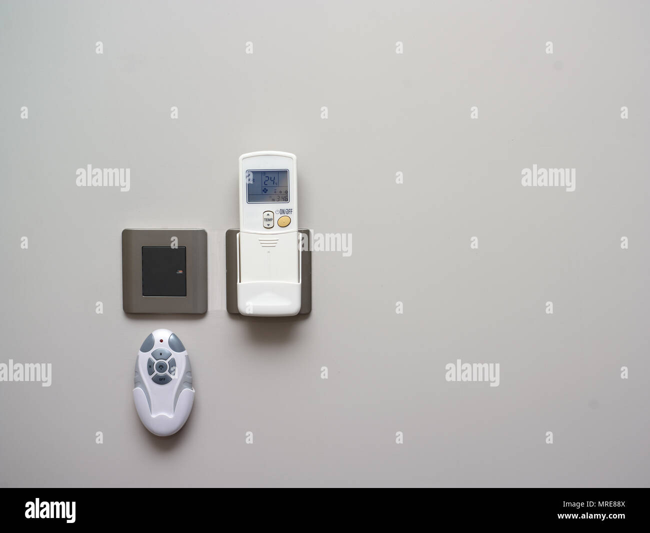 Various remote controls hanging on the wall, indoor closeup Stock Photo