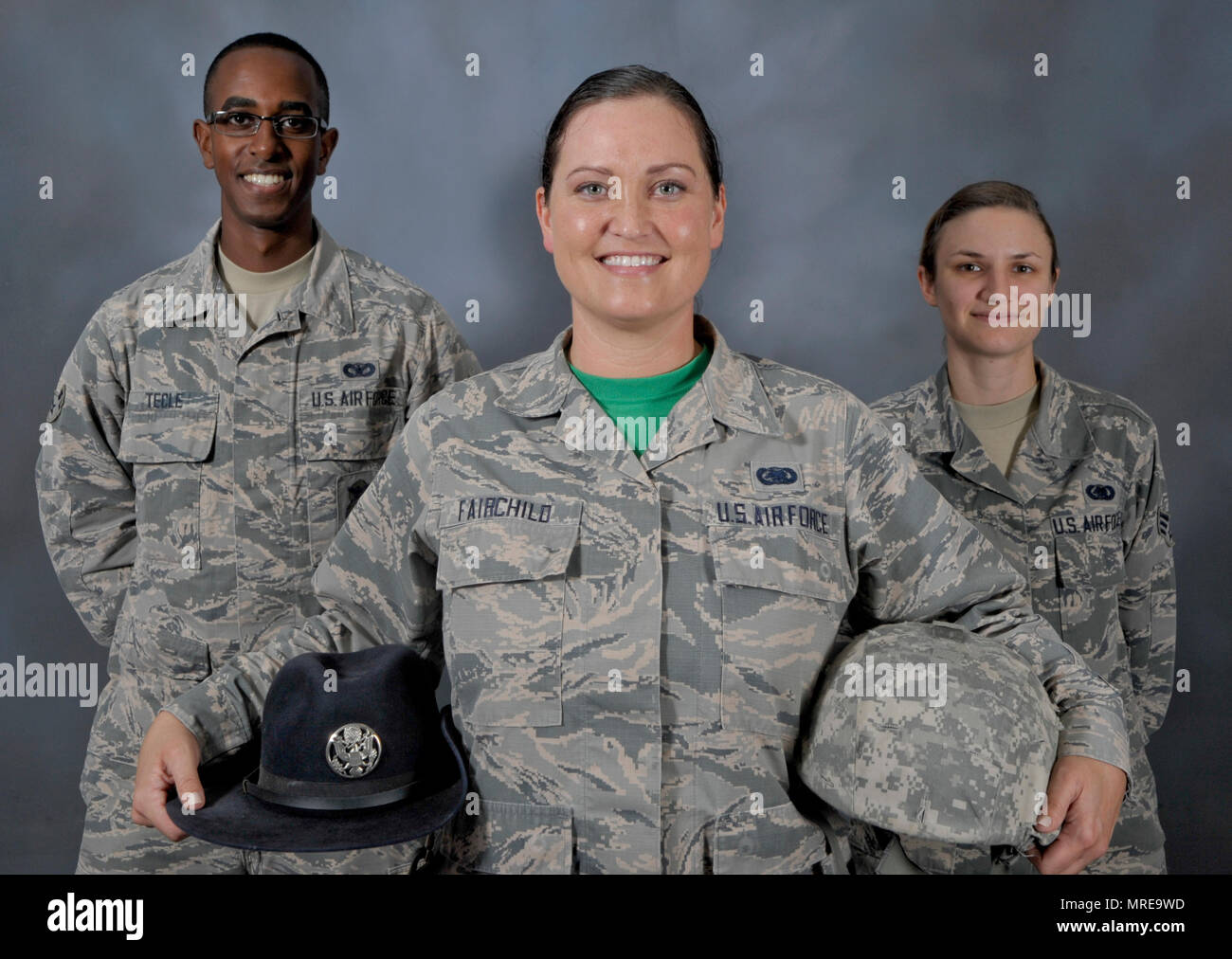 Staff Sgt. Jessica Fairchild, center, a former military training instructor and currently an individual protective equipment supervisor assigned to the 6th Logistics Readiness Squadron, pauses for a photo with Airman 1st Class Zenawi Tecle, left, a former trainee of Fairchild and now an entry controller with the 6th Security Forces Squadron, and Senior Airman Kristin Weiland, right, an individual protective equipment technician with the 6th LRS, Feb. 24, 2017, at MacDill Air Force Base, Fla. Fairchild served four years as an MTI applying professionalism and dedication to train thousands of peo Stock Photo