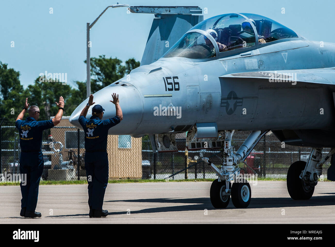 Members of the U.S. Navy Tactical Demonstration Team check the outer exterior of the F-18 Super Hornet before take off during the 100th Centennial Celebration Air Show, June 10, 2017, at Scott Air Force Base, Ill. Boeing offers a suite of upgrades to the F/A-18 Super Hornet, including conformal fuel tanks, an enclosed weapons pod, an enhanced engine and a reduced radar signature. These capabilities, along with other advanced technologies, offer U.S. and international customers a menu of next-generation capabilities to outpace future threats affordably. (U.S. Air Force photo/Senior Airman Trist Stock Photo