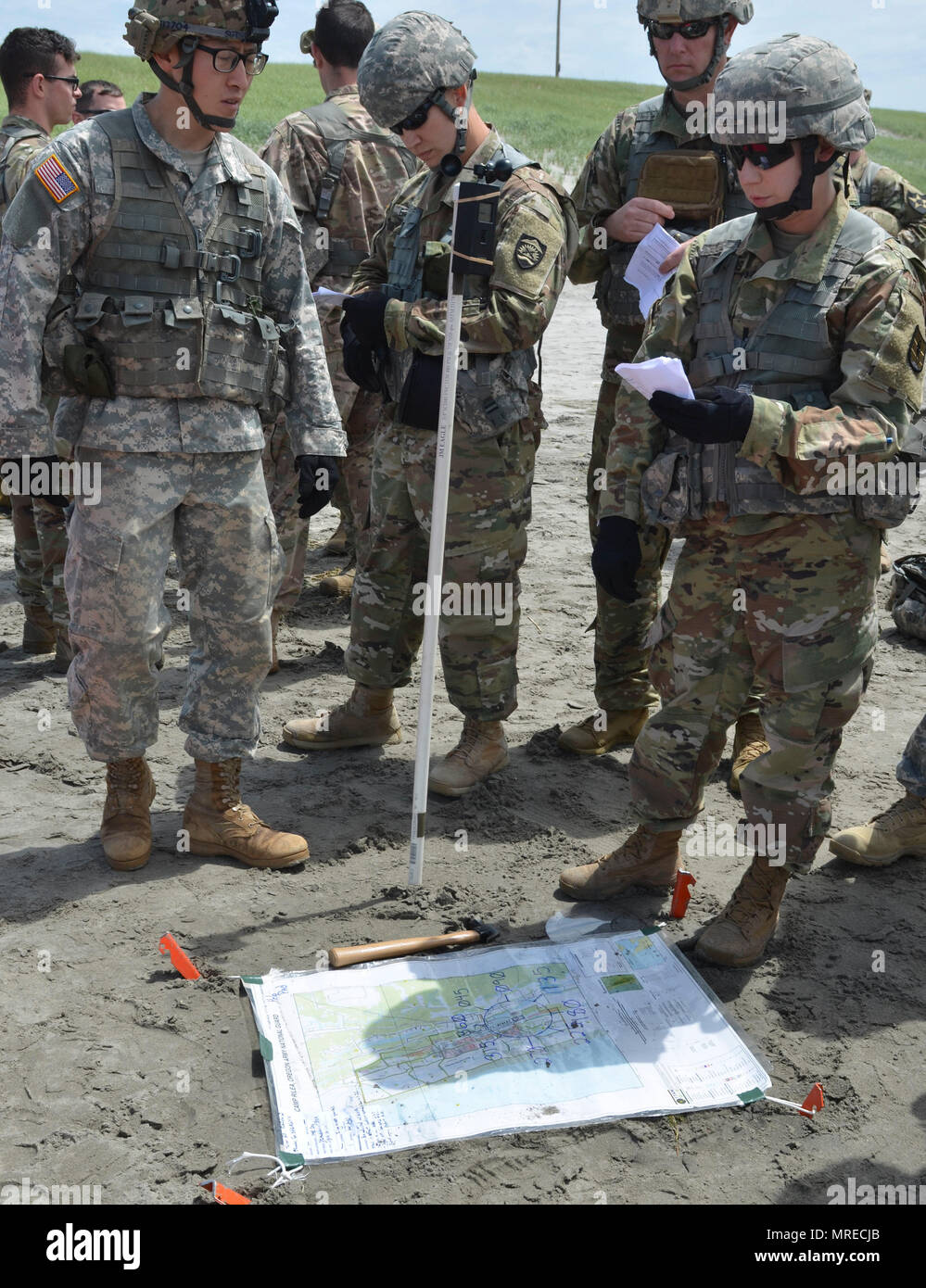 Soldiers and Airmen check wind and weather conditions during the Pathfinder course held at Camp Rilea in Warrenton, Oregon, June 7, 2017. The students learned how to negotiate the weather’s influence on a UH-60 Black Hawk helicopter as it prepares to drop a package in a designated drop zone. (Photo by Staff Sgt. Anita VanderMolen, 115th Mobile Public Affairs Detachment) Stock Photo