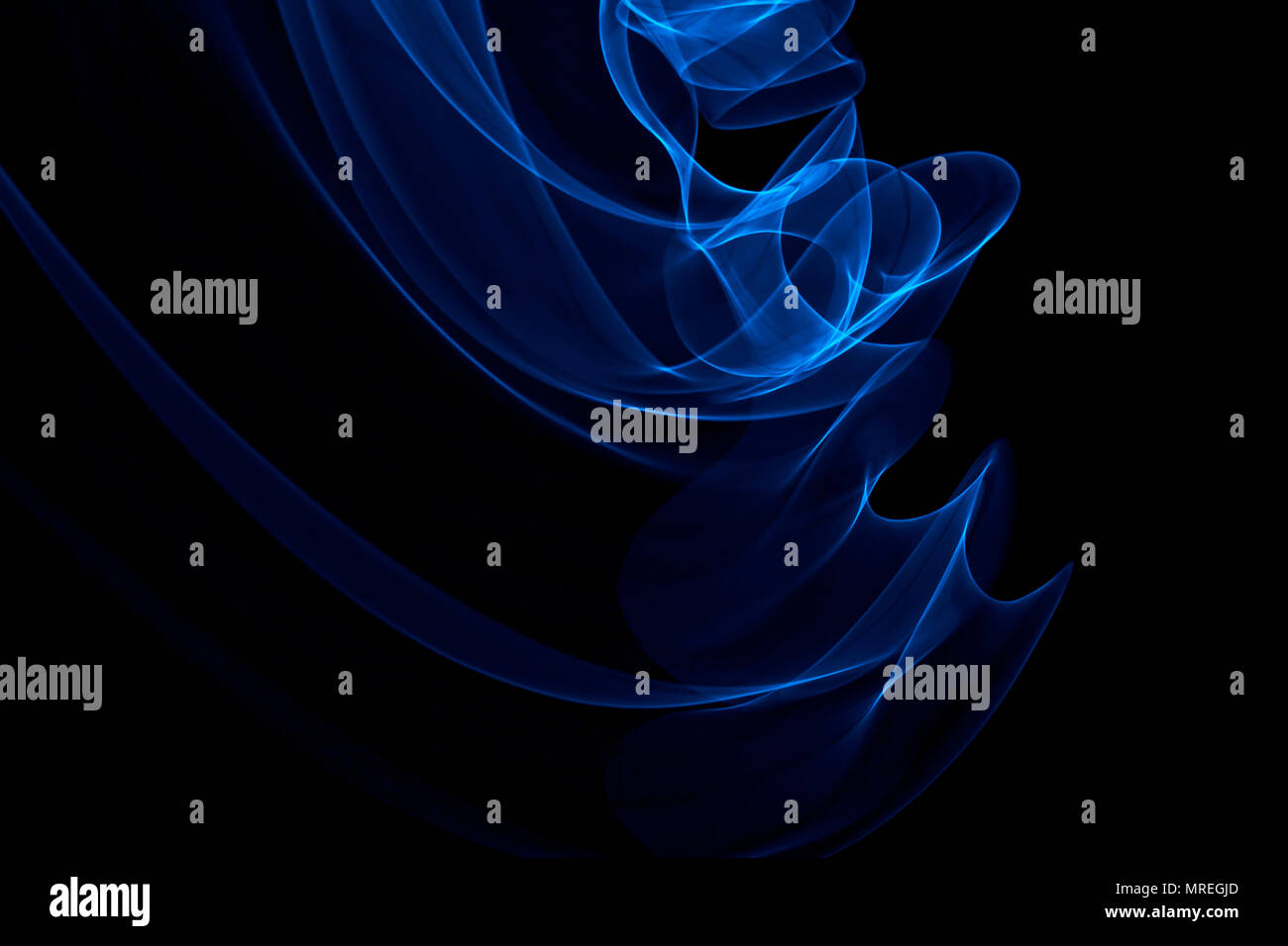 Light painted glowing abstract blue curved lines on a black background ...