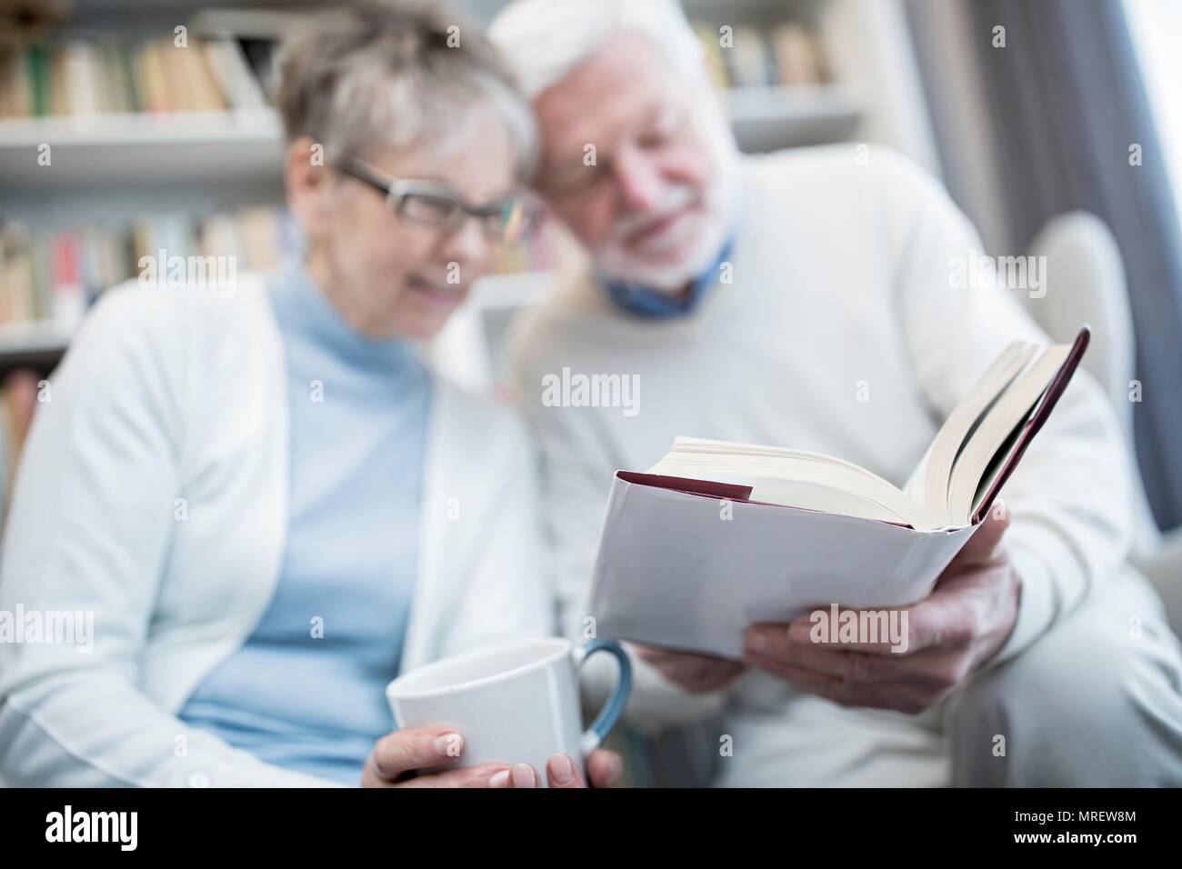 Senior couple reading book. Stock Photo
