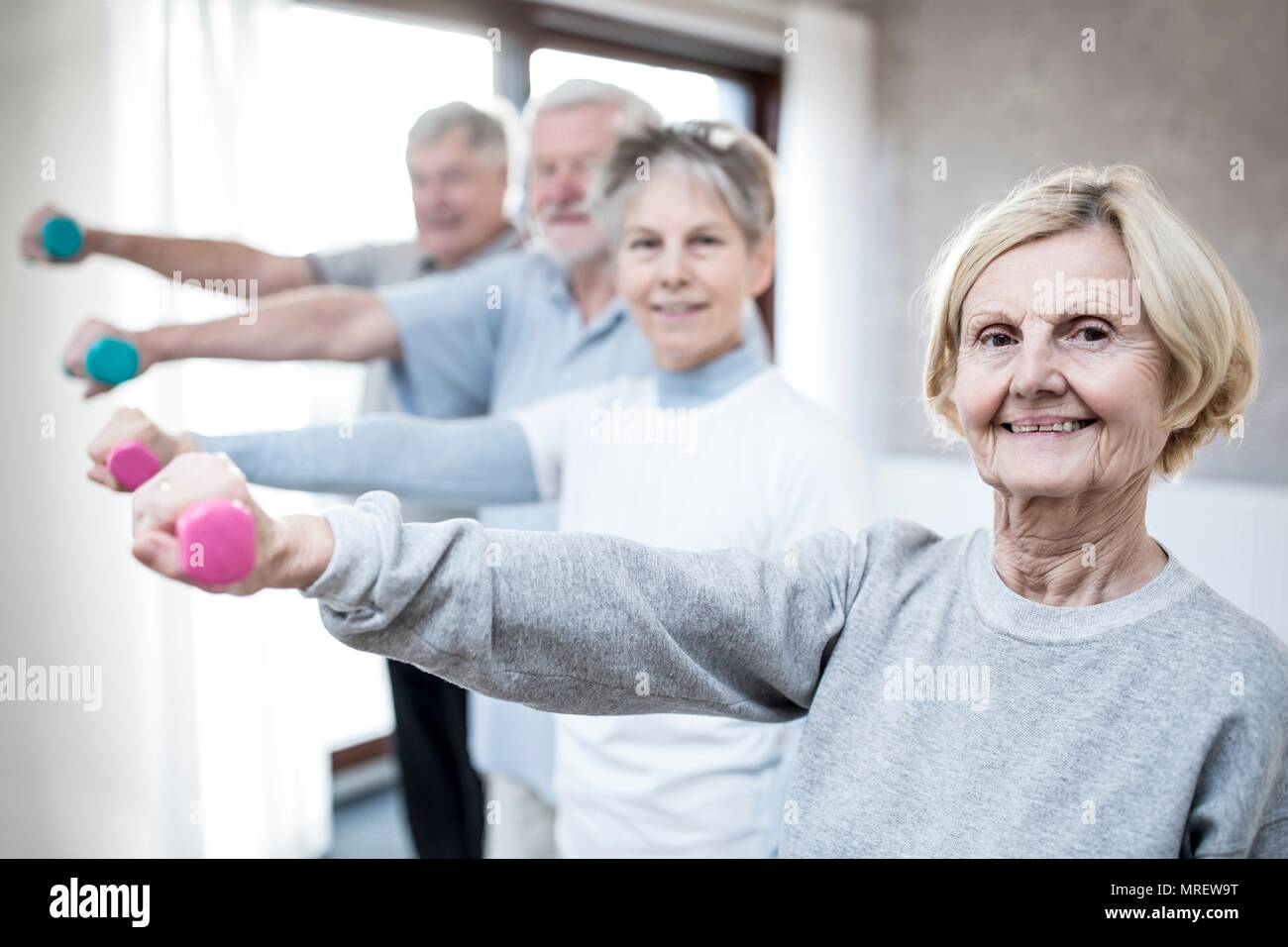 Senior adults holding hand weights. Stock Photo