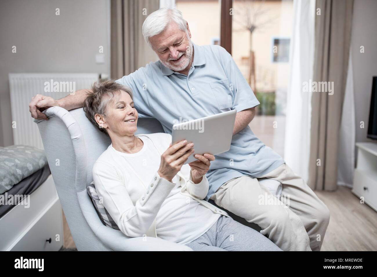 Senior couple in hospital room looking at digital tablet. Stock Photo