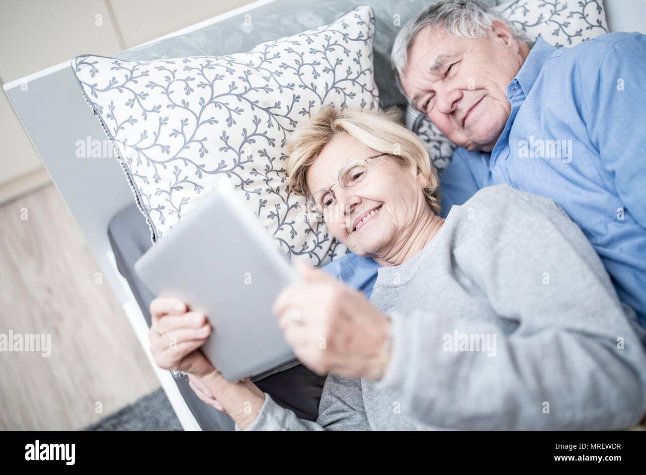 Senior couple looking at digital tablet. Stock Photo