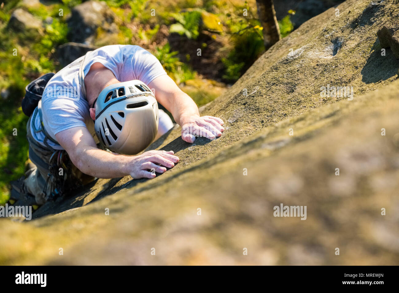 Man Rock climbing at the Paradise Wall area of Stanage in the Peak District National Park, UK Stock Photo