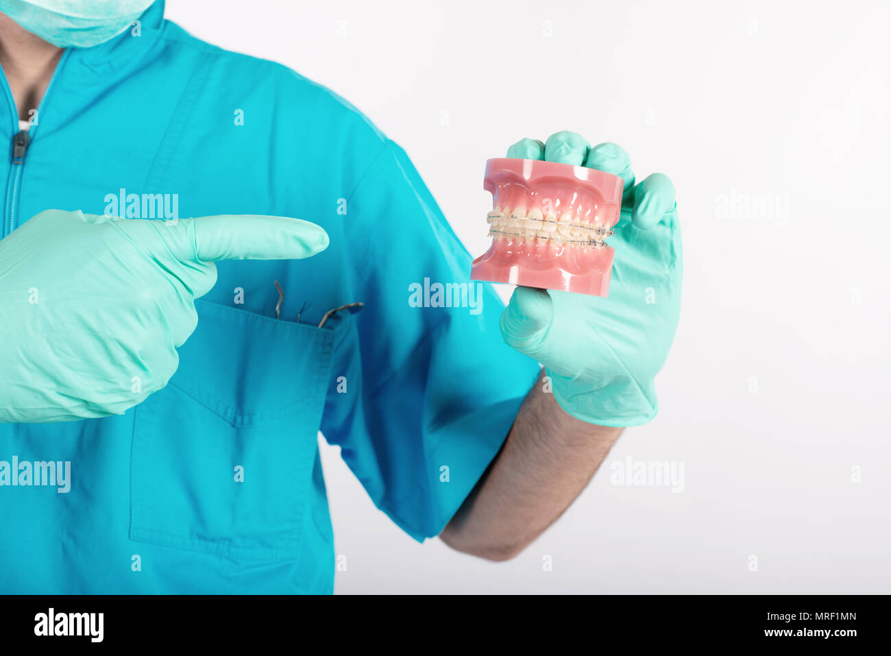 Dentist shows how to apply a brace Stock Photo