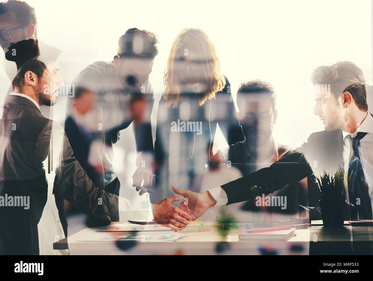 Handshaking business person in office. concept of teamwork and partnership. double exposure Stock Photo