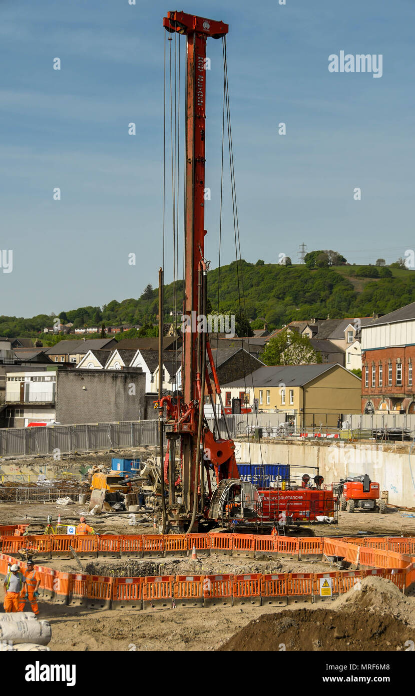Drilling rig preparing foundations on the site of a new office development in Pontypridd town