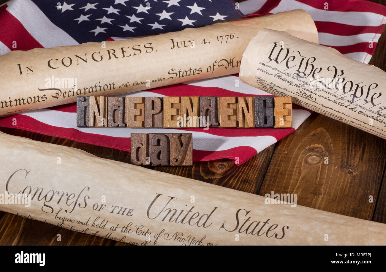 'Independence Day' banner using wooden letters with the Declaration of Independence, US Constitution and Bill of Rights, and United States flag Stock Photo