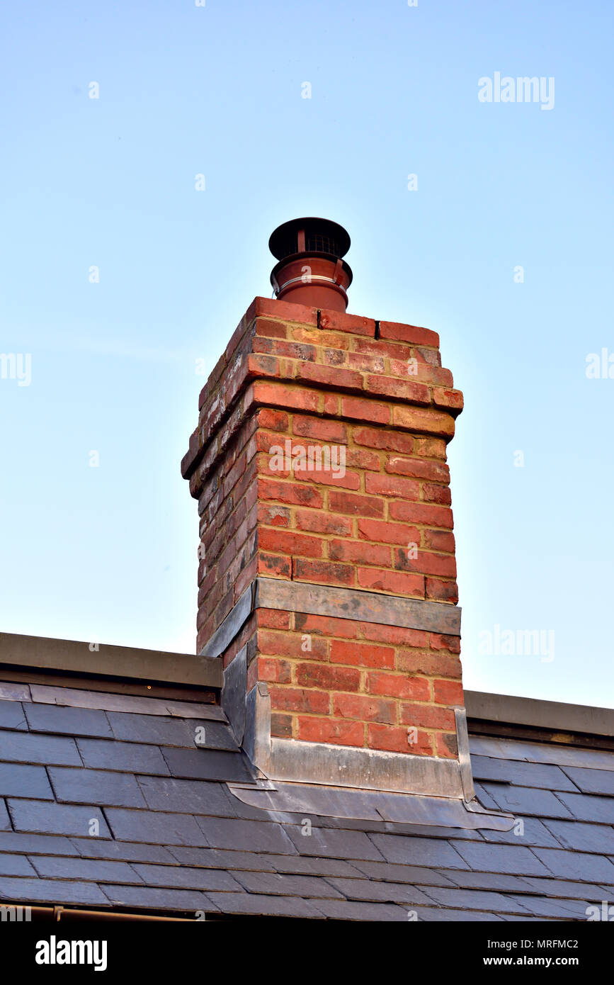 Good practice and example of lead flashing on domestic fireplace chimney with slat roof, UK Stock Photo