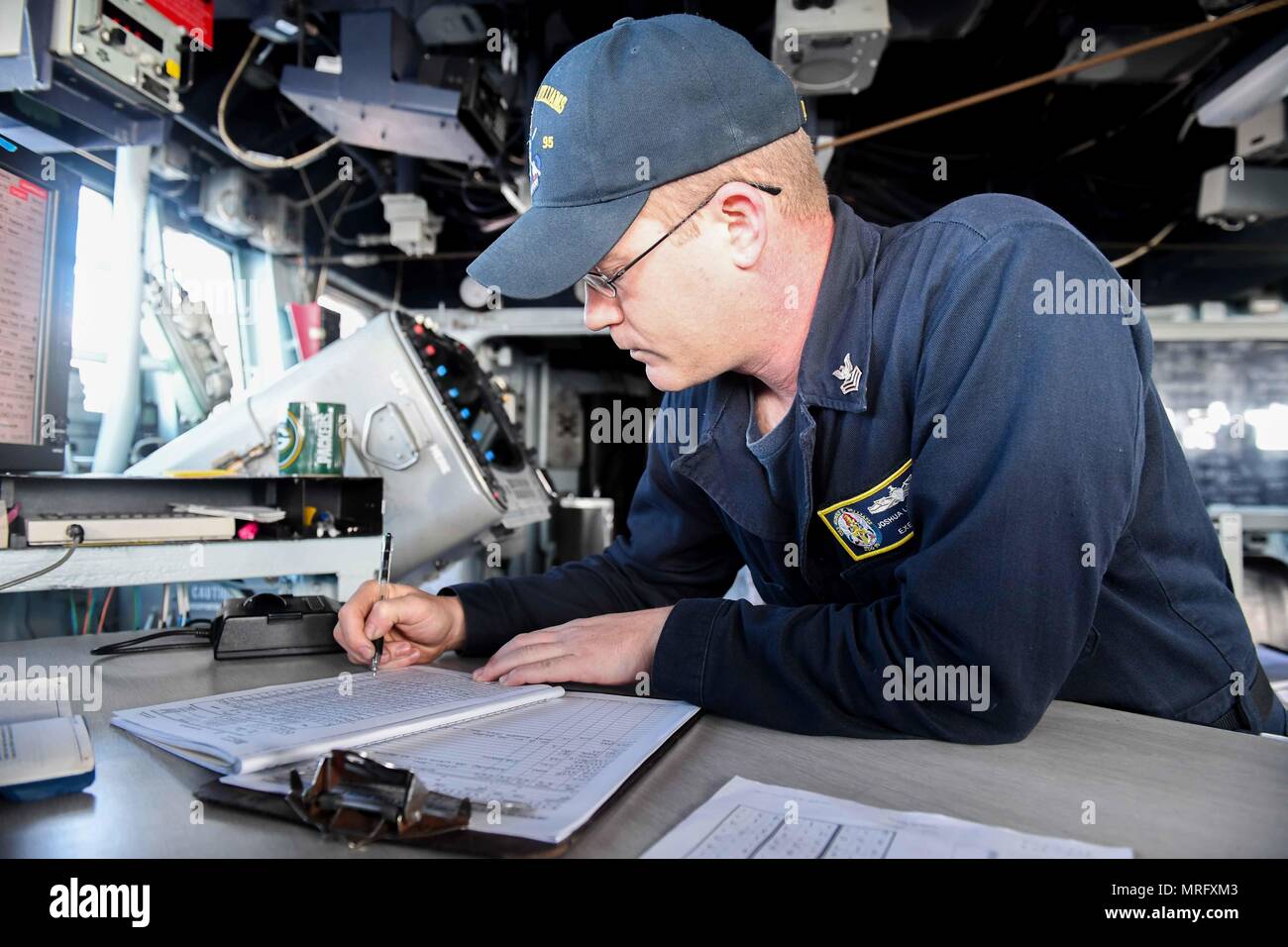 170612-N-GX781-133 BALTIC SEA (June 12, 2017) - Quartermaster 1st Class Joshua Livangood, from Superior, Wisconsin, records information in the deck logs aboard the Arleigh Burke-class guided-missile destroyer USS James E. Williams (DDG 95) during exercise BALTOPS 2017, June 12. BALTOPS 17 is the premier annual maritime-focused exercise in the Baltic Region and one of the largest exercises in Northern Europe. (U.S. Navy photo by Mass Communication Specialist 3rd Class Colbey Livingston/Released) Stock Photo