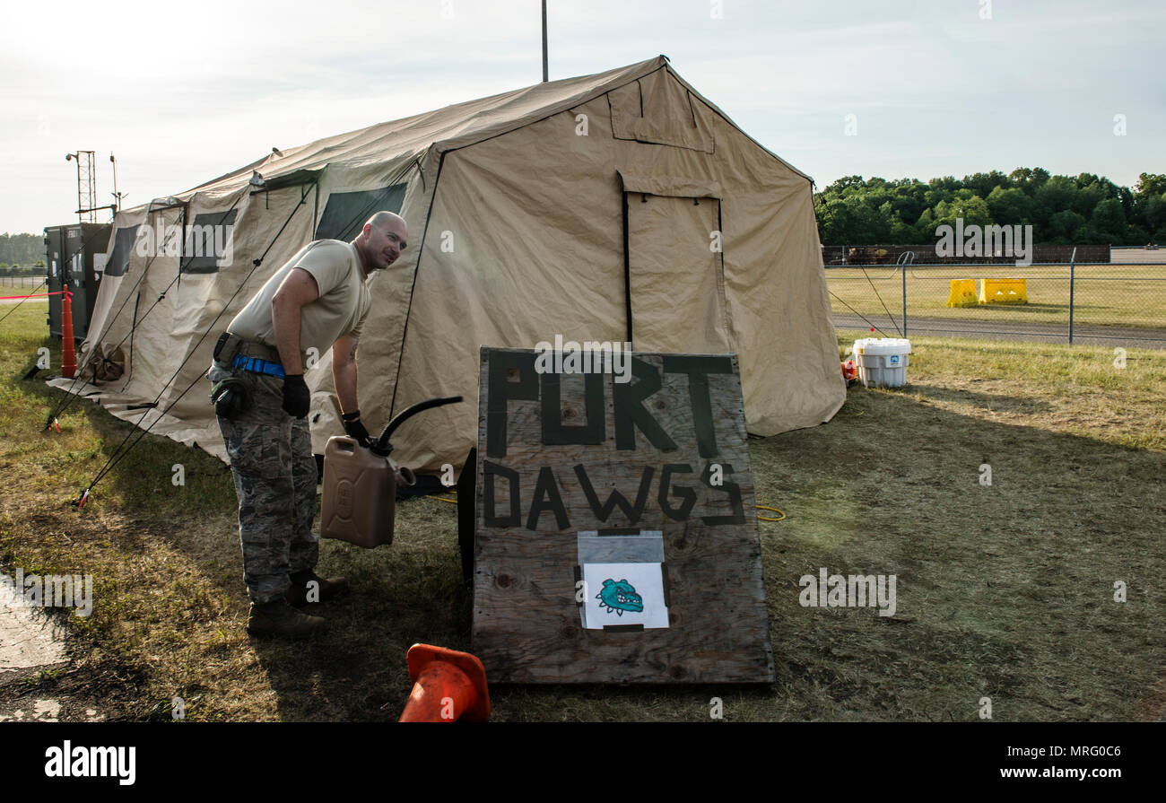U.S. Air Force Tech. Sgt. Jason Green, 821st Contingency Response Squadron, air transportation, prepares to put gasl into a tent generator during a medical exercise at Battle Creek Air National Guard Base, Michigan, on June 11, 2017. Turbo Distribution 17-2 is a U.S. Transportation Command exercise designed to assess the Joint Task Force-Port Opening’s ability to deliver and distribute cargo during humanitarian and disaster relief operations. (U.S. Air Force photo by Senior Airman Xavier Navarro) Stock Photo