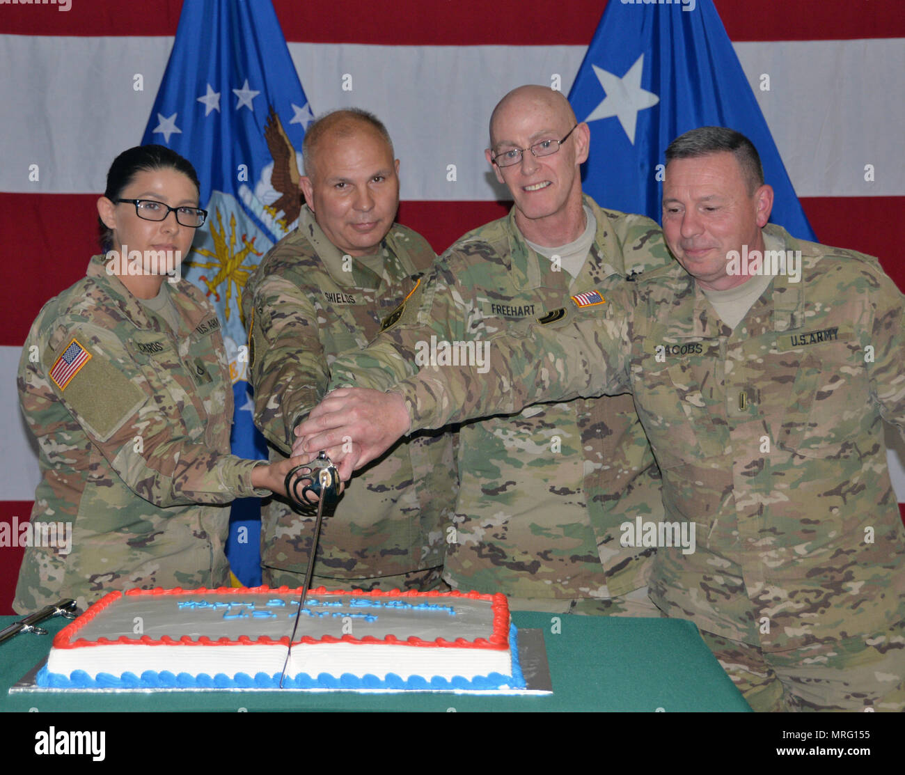 Youngest and oldest Soldiers present cut the birthday cake during Army Birthday ceremonies at New York National Guard Headquarters in Latham, N.Y. on June 17, 2017. Cutting the cake are, from left, PFC Jade Richards, the youngest Solldier, Brig. Gen. Raymond Shields, commander of the New York Army National Guard, Col. James Freehart, the oldest Soldier present, and Chief Warrant Officer 5 Gordon Jacobs, another Army veteran.New York Army National Guard members celebrated the 242nd Birthday of the United States Army. (U.S. Army National Guard photo by: Sgt. Major Corine Lombardo) Stock Photo