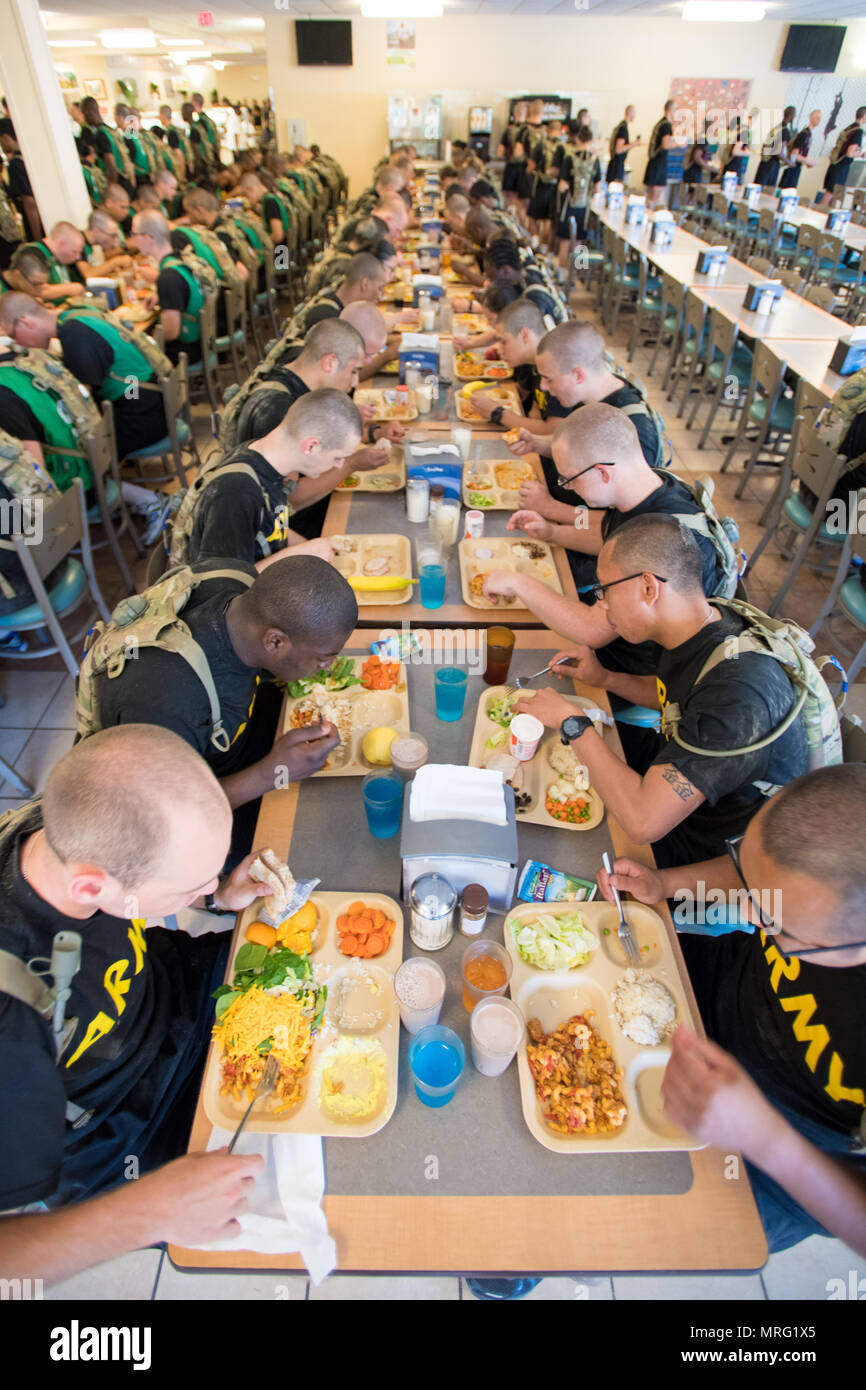 U.S. Army Trainees assigned to Foxtrot 1st Battalion 34th Infantry Regiment eat lunch at the Dinning Facilities Administration Center for the first time on the Third day of Basic Combat Training on 14 June 2017 at Fort Jackson, SC.  Among those assigned to the 1st Battalion, 34th Infantry Regiment are Reserve Drill Sergeants from the 3rd Battalion, 518th Infantry Regiment who are required to serve two weeks for annual training (U.S. Army photo by Sgt. Darius Davis/Released). Stock Photo