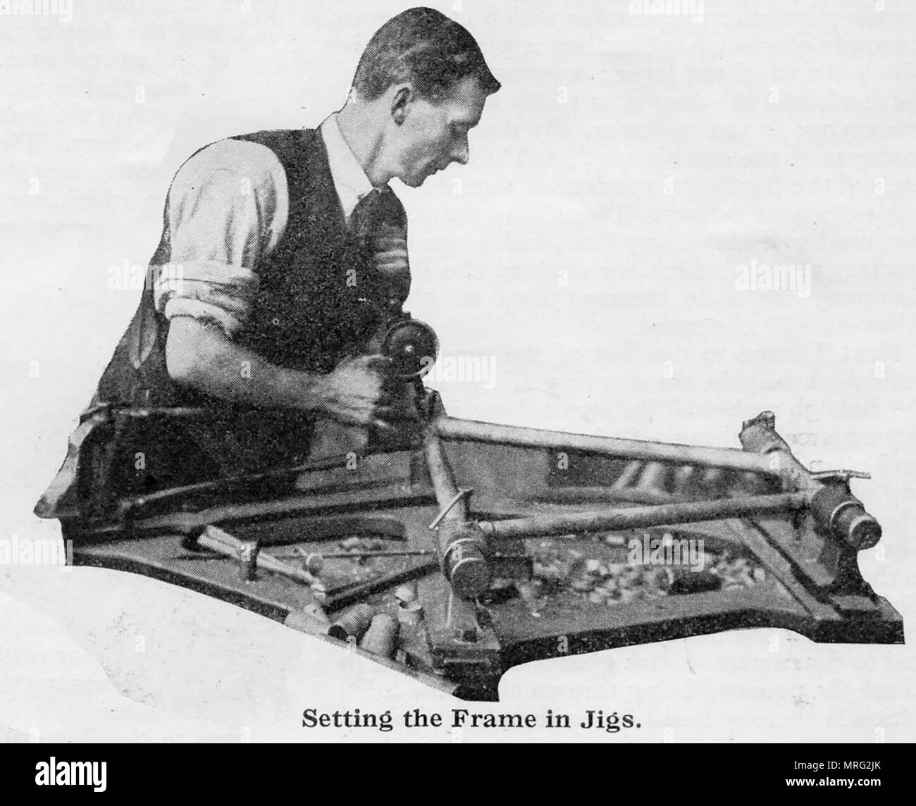 1932 Hand building bicycles at the Raleigh factory Nottingham, UK - Constructing the bicycle frame Stock Photo