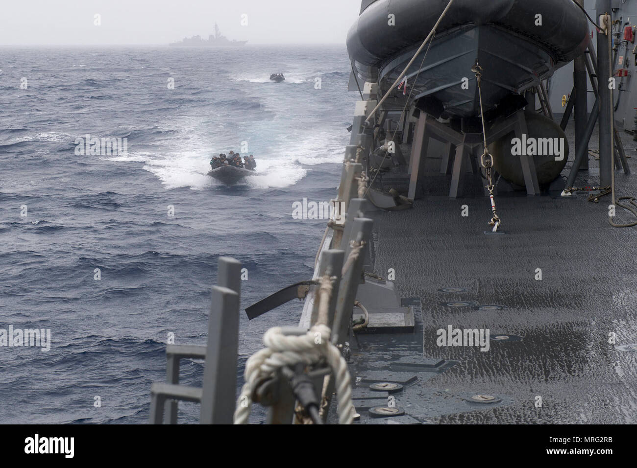 170610-N-ZW825-1204 SOUTH CHINA SEA (June 10, 2017) Rigid-hull inflatable boats from Japan Maritime Self-Defense Force (JMSDF) ship JS Sazanami (DD 113) approach Arleigh Burke-class guided-missile destroyer USS Sterett (DDG 104) as part of a visit, board, search and seizure exercise. Sterett, Sazanami, JMSDF ship JS Izumo (DDH 183), Royal Canadian Navy ship HMCS Winnipeg (338) and Royal Australian Navy ship HMAS Ballarat (FFH 155) conducted a series of maritime operations together in the South China Sea. Sterett is part of the Sterett-Dewey Surface Action Group and is the third deploying group Stock Photo