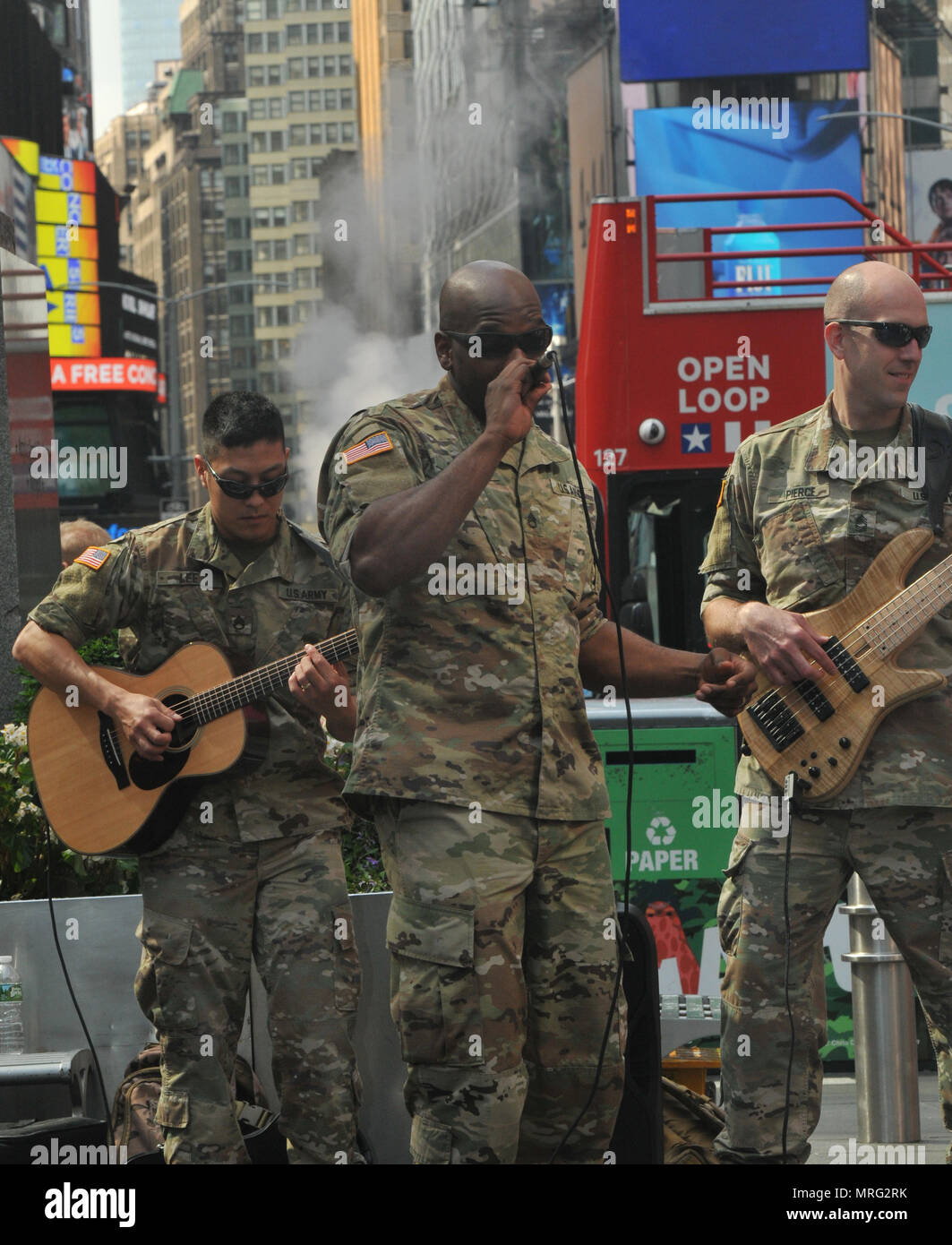 Staff Sgt. Jeremy Gaynor, alongside SSG Jongyoon Lee (left) and Master Sgt. Dan Pierce, with the West Point Benny Havens Band, perform in New York City's Times Square for the Army's 242nd Birthday. Members of the Benny Havens Band did a parks and subways tour throughout the city by playing six mini-concerts in various locations to highlight the Army's Birthday. (U.S. Army photo by Staff Sgt. Alejandro Canizales (released). Stock Photo