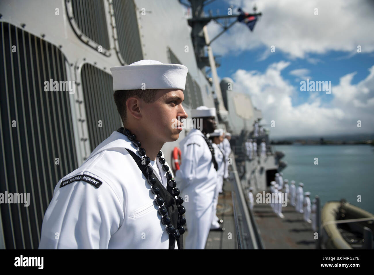 170613-N-PP996-058 PEARL HARBOR (June 13, 2017) Machinist’s Mate 2nd Class Nick Magarelli, from Fair Lawn, New Jersey, mans the rails aboard Arleigh Burke-class guided-missile destroyer USS Michael Murphy (DDG 112) as the ship returns to its homeport Joint Base Pearl Harbor-Hickam after a 5-month deployment. Michael Murphy was on a Western Pacific deployment in the Indo-Asia-Pacific region as part of the Carl Vinson Carrier Strike Group. (U.S. Navy photo by Mass Communication Specialist 3rd Class Danny Kelley/Released) Stock Photo