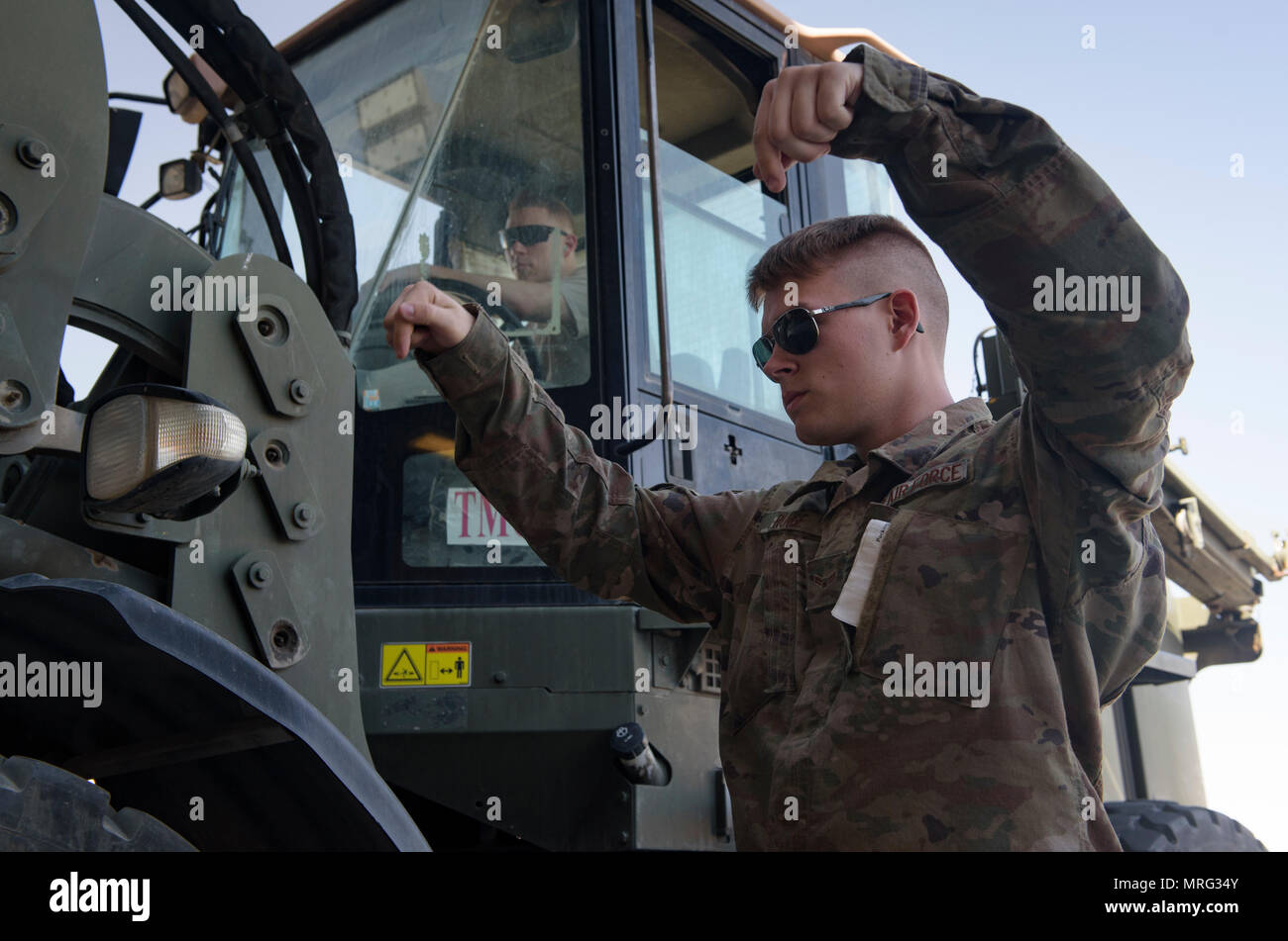 Airman 1st Class Blaine Runge directs a forklift operator, Senior Airman Giovany Tellez, both with the 455th Expeditionary Logistics Readiness Squadron traffic management office, where to unload a crate at Bagram Airfield, Afghanistan, June 13, 2017. The 455th ELRS TMO receives and processes every shipment that comes through Bagram Airfield. (U.S. Air Force photo by Staff Sgt. Benjamin Gonsier) Stock Photo
