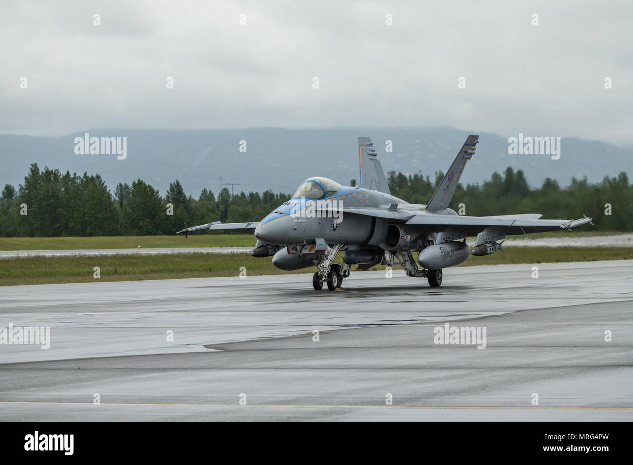 A U.S. Marine Corps F/A-18C Hornet with Marine Fighter Attack Squadron 251 is taxis down a flightline during a joint training exercise Red Flag-Alaska 17-2 on Joint Base Elmendorf-Richardson, Alaska, June 13, 2017. Red Flag-Alaska provides an optimal training environment in the Indo-Asian Pacific region and focuses on improving ground, space, and cyberspace combat readiness and interoperability for U.S. and international forces. (U.S. Marine Corps photo by Lance Cpl. Koby I. Saunders) Stock Photo