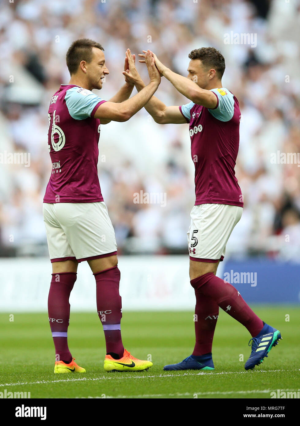 Aston Villa's John Terry (left) greets team-mate James Chester during the Sky Bet Championship Final at Wembley Stadium, London. Stock Photo