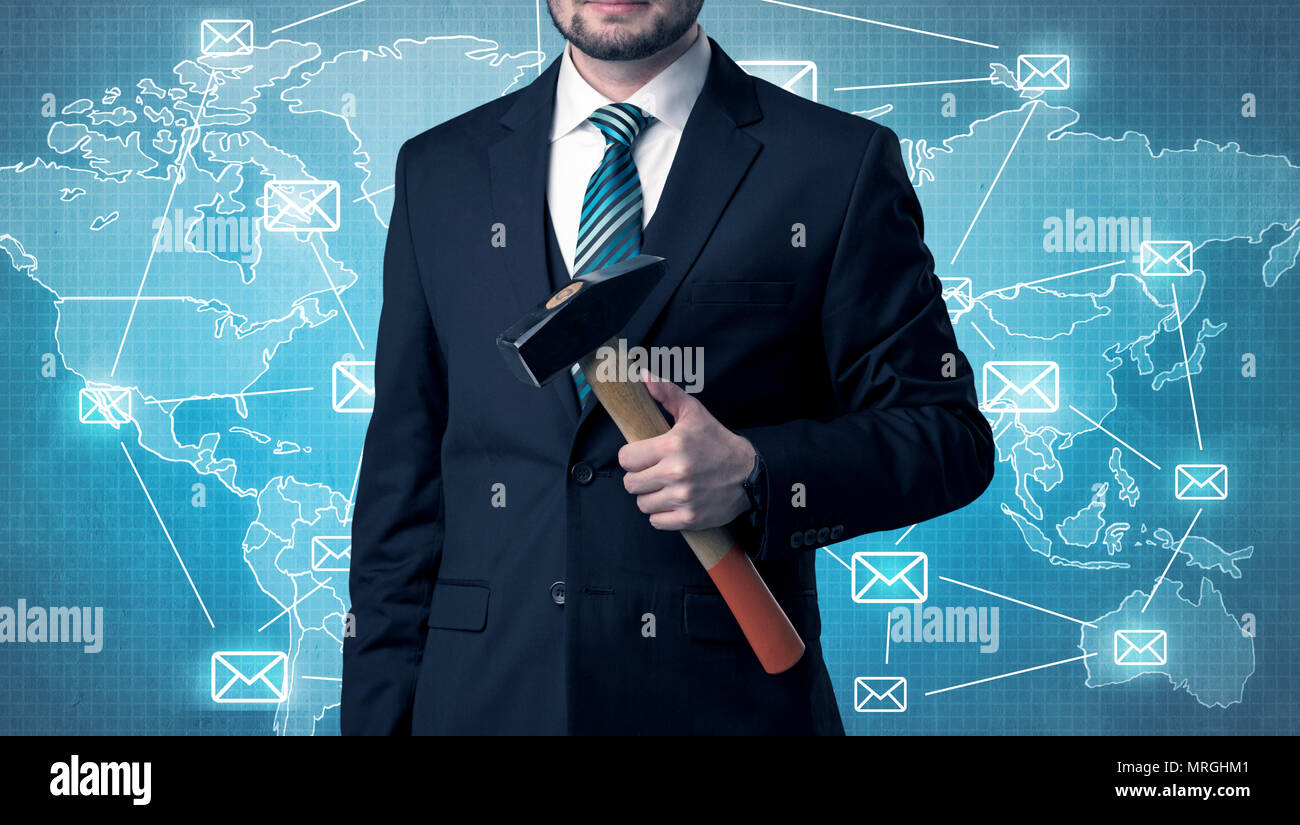 Businessman holding tool with global map graphic on the background Stock Photo