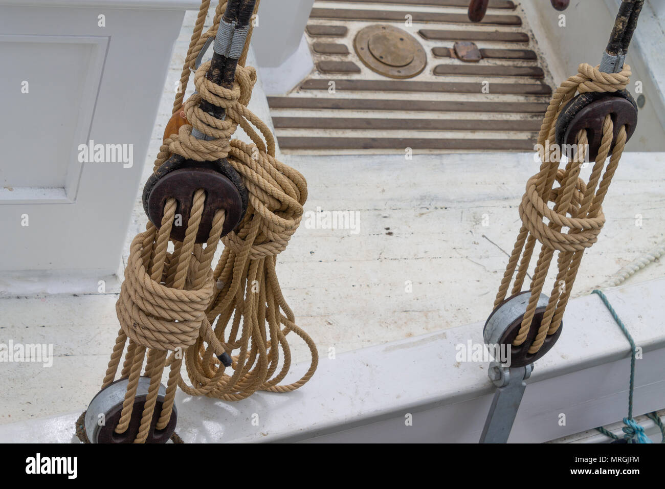 wooden block and tackle lashed and stowed as part of the rigging on a sailing boat. Stock Photo