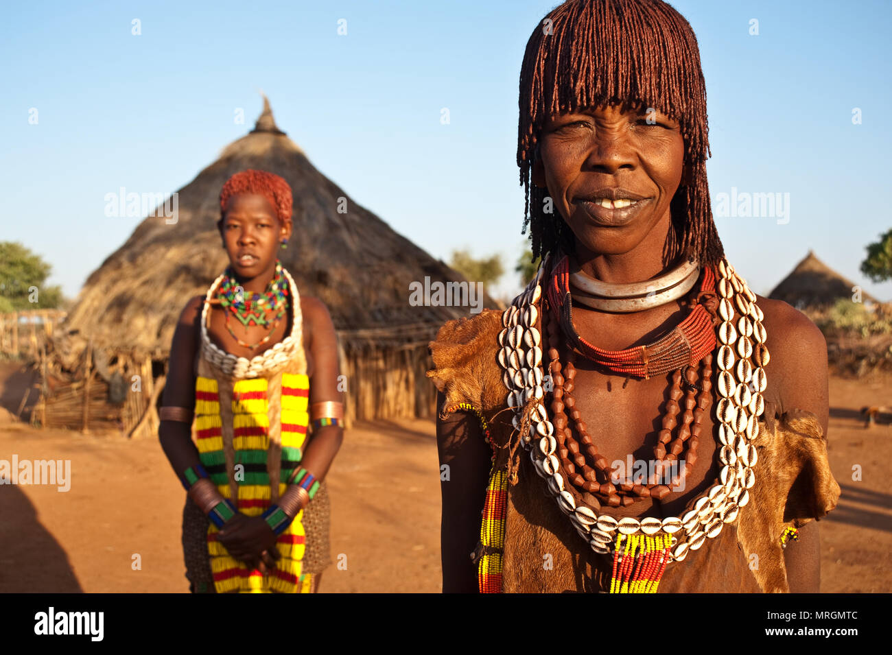 Mother and daughter from the Hamer tribe ( Ethiopia). They are wearing ...