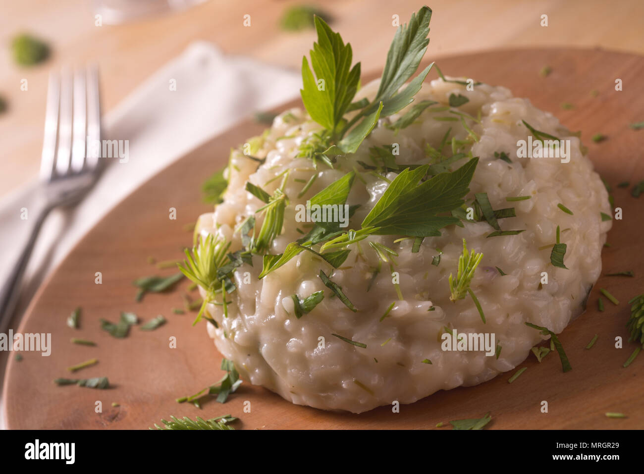 Risotto with gem fit and levisticum celery on a wood table composition Stock Photo
