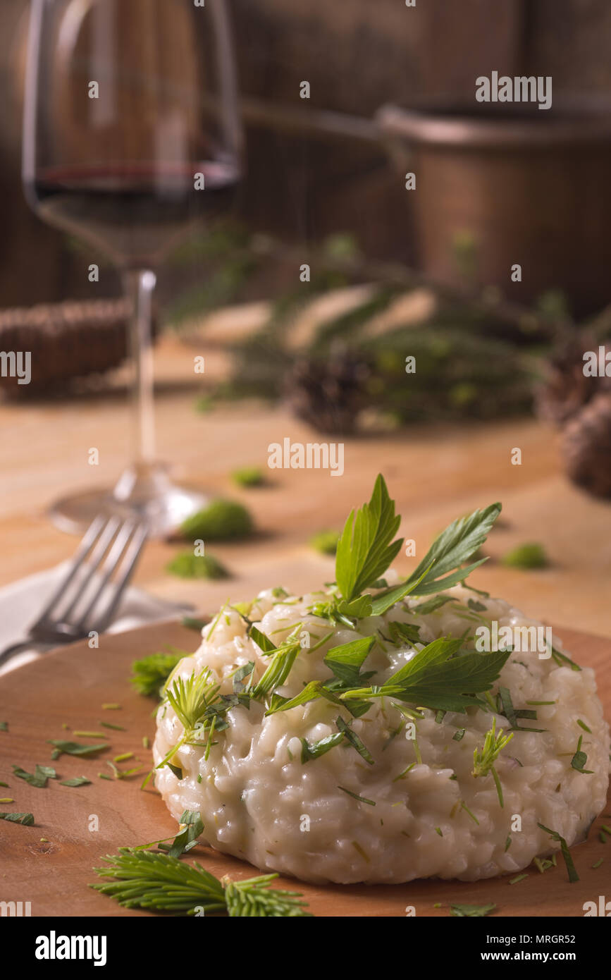 Risotto with gem fit and levisticum celery on a wood table composition Stock Photo