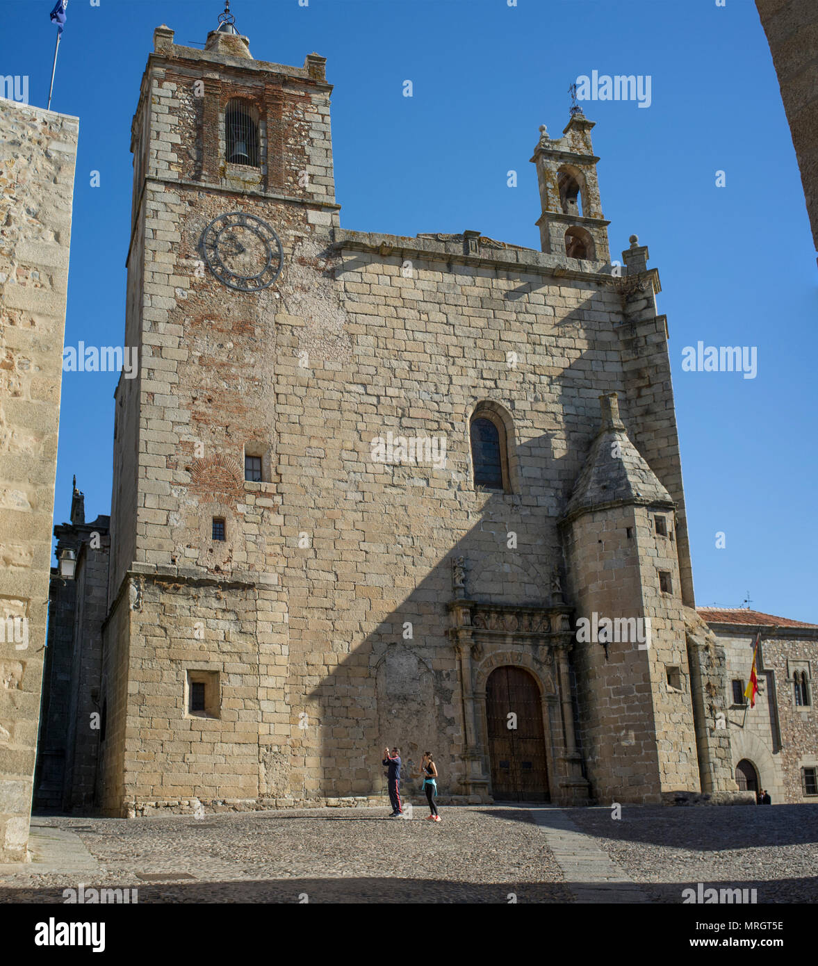 Visitors beside St Matthew's Church, Caceres historic quarter, Spain Stock Photo