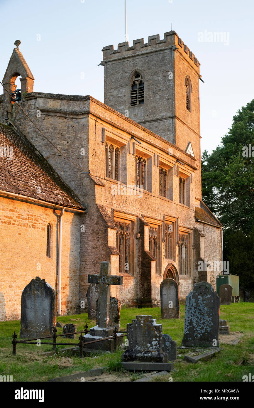 Evening sunlight on St Leonard's church in the village of Bledington, Cotswolds, Gloucestershire, England Stock Photo