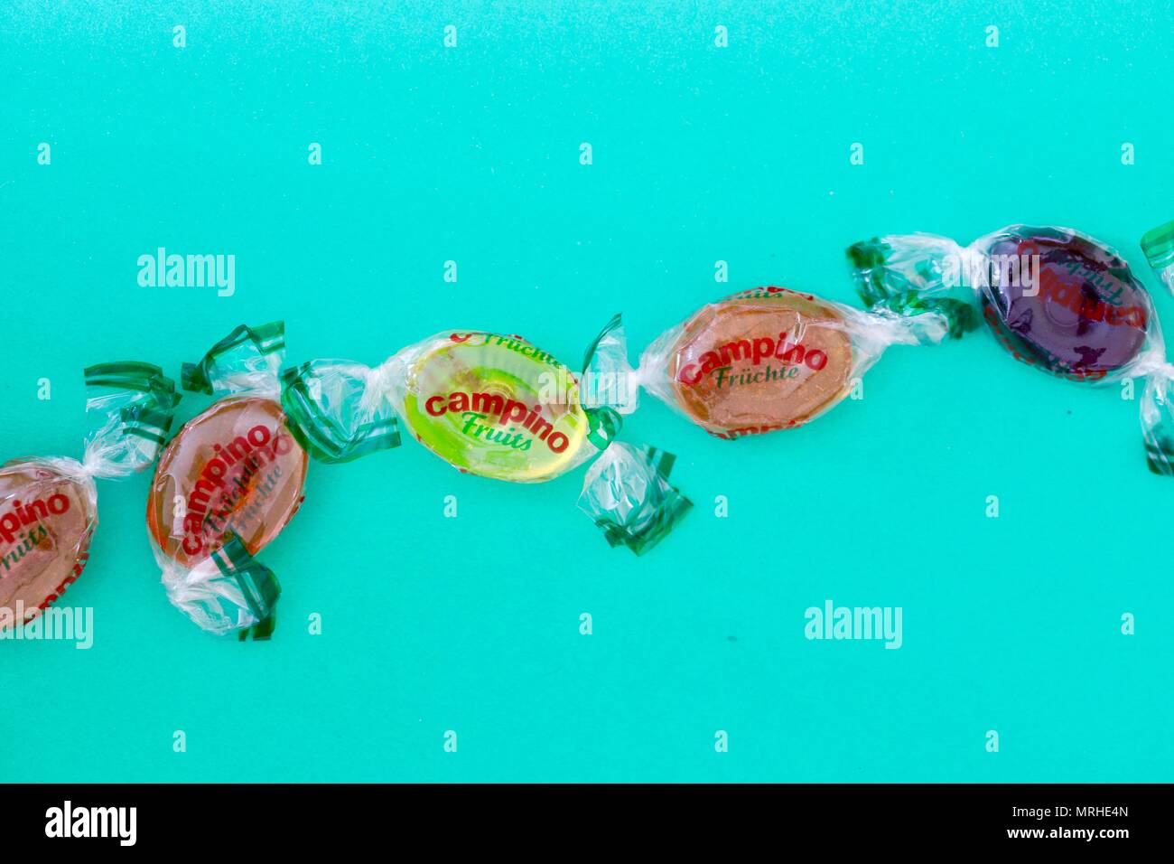 Campino boiled fruit flavoured sweets on a turquoise background. Stock Photo