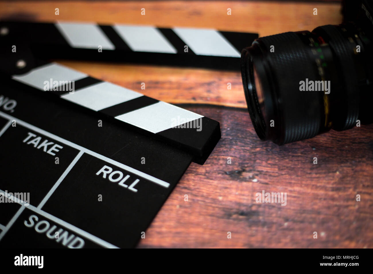 Movie clapper and old camera on a wooden background, movie shooting ...