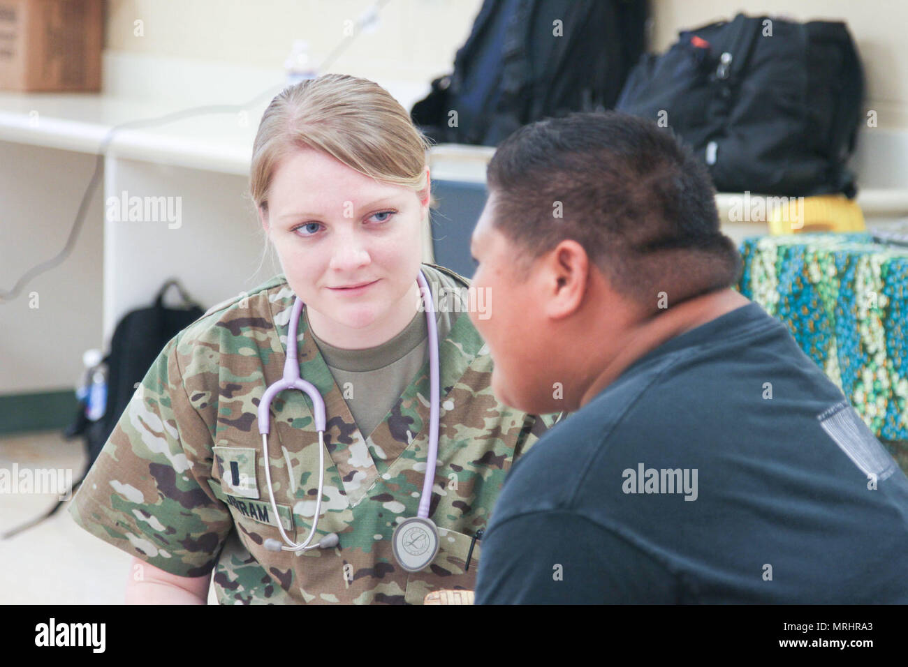 U.S. Army Reserve 1Lt. Miranda Jerran, a nurse with the 48th Combat Support Hospital B Co. from Newark, Delaware chats with a member of the special needs community June 16, 2017 on the Island of Kauai, Hawaii during Operation Tropic Care 2017. Tropic Care was a joint service operation that asissted in addressing the Kauai community healthcare needs at no cost while allowing the Army Reserve Soldiers to train on their mission-essential expeditionary tasks. (U.S. Army Reserve photo by Sgt. Ian Valley 345th Public Affairs Detachment) Stock Photo