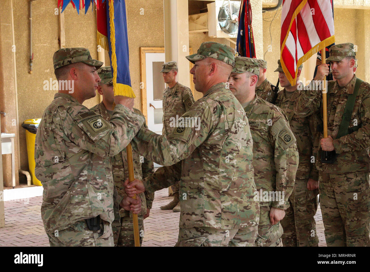 Outgoing Command Sgt. Maj. Mitchell Rucker hands the brigade colors to ...