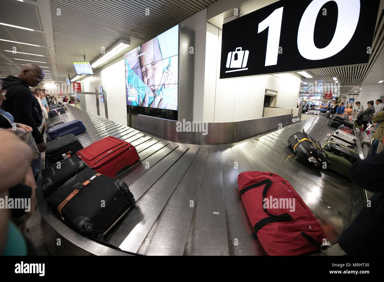 Transport tape, luggage tourists people waiting for suitcase. Rome Fiumicino airport. Italy